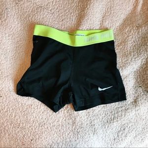 black nike pros with green band